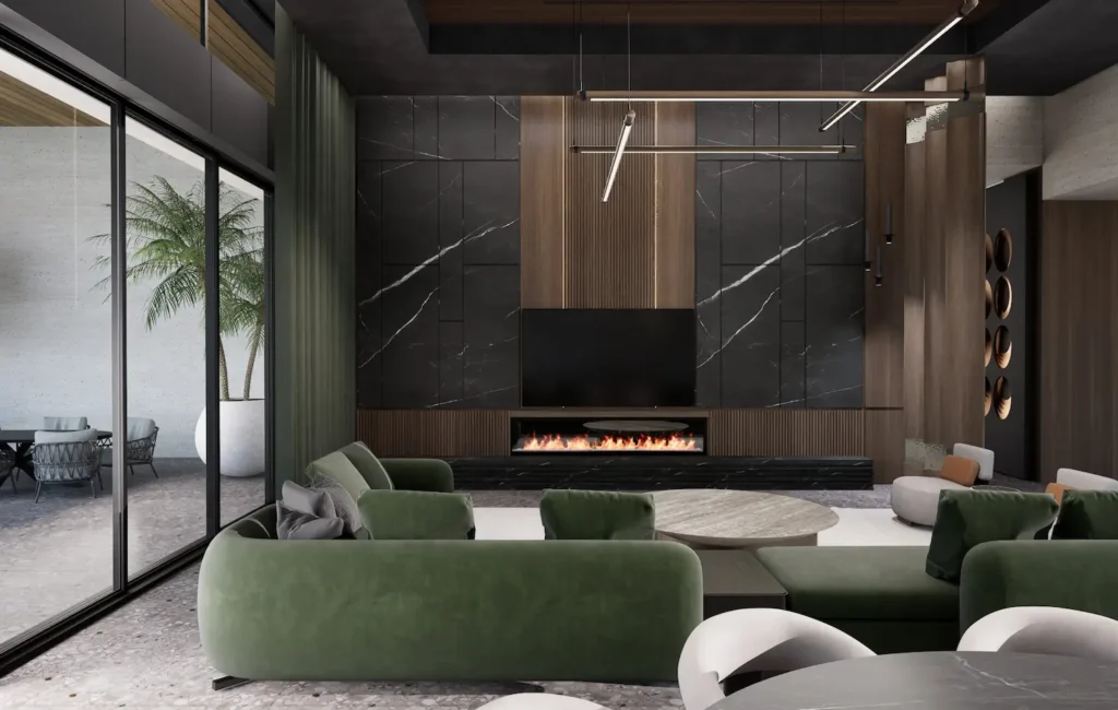A luxury living room featuring a curved emerald green velvet sectional sofa, a black marble and wood-paneled media wall with an integrated linear fireplace, and floor-to-ceiling glass doors leading to a terrace with a palm tree.