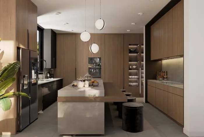 A sleek, modern kitchen by Sean Design featuring floor-to-ceiling wood cabinetry, a large concrete island with an attached wood breakfast bar, and three spherical pendant lights. The space includes integrated high-end appliances, black velvet stools, and soft natural lighting.