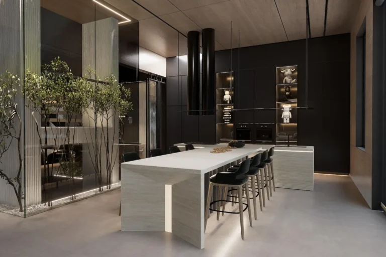 A dark, minimalist kitchen featuring a large white stone island with under-lighting, black cabinetry, and an indoor glass-enclosed garden.